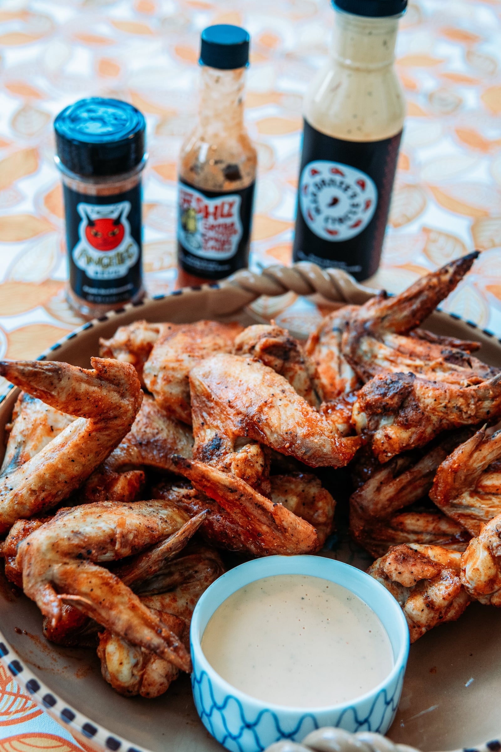 Chicken wings displayed with the sauces used in the recipe